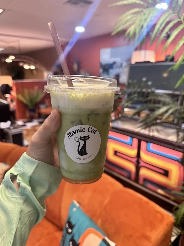 Iced matcha latte with banana cold foam at Atomic Cat Cafe